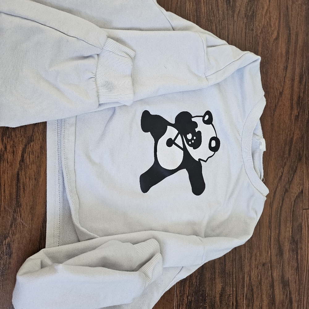 a super cute white sweatshirt for kids featuring a dabbing panda on it!